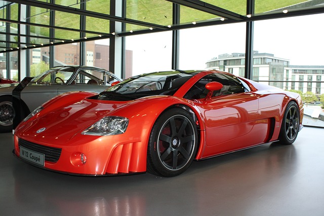 An image showcasing the vibrant hues of Kauai's lush scenery, with a sleek, modern car rental tucked amidst the towering emerald mountains, cascading waterfalls, and crystal-clear turquoise beaches